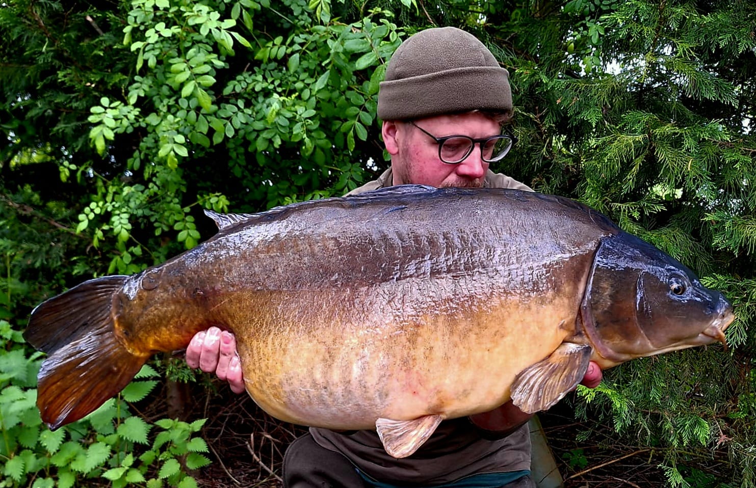 Man holding fish he caught at Ringwood Angling Club
