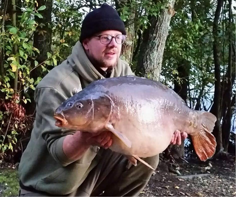 Man holding fish he caught at Ringwood Angling Club